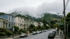 Fog spilling over green hills